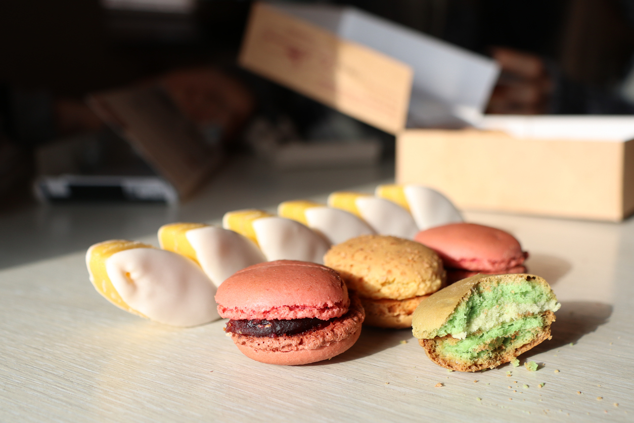 A vibrant and colorful display of delicious macarons and assorted pastries