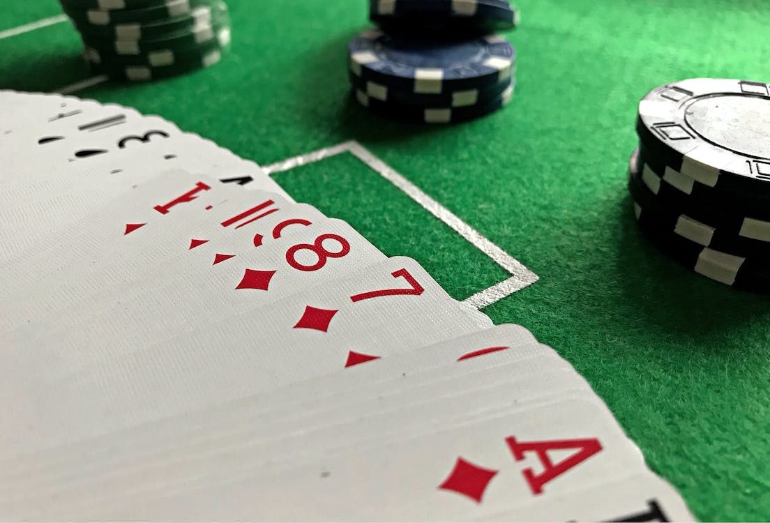 casino table with playing cards and poker chips