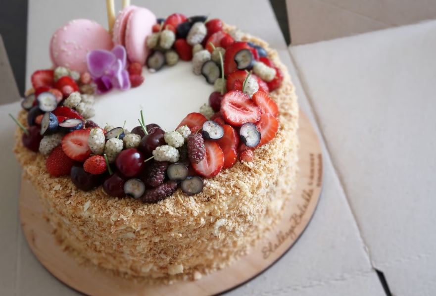 A cheesecake on a plate with a bunch of candies on top