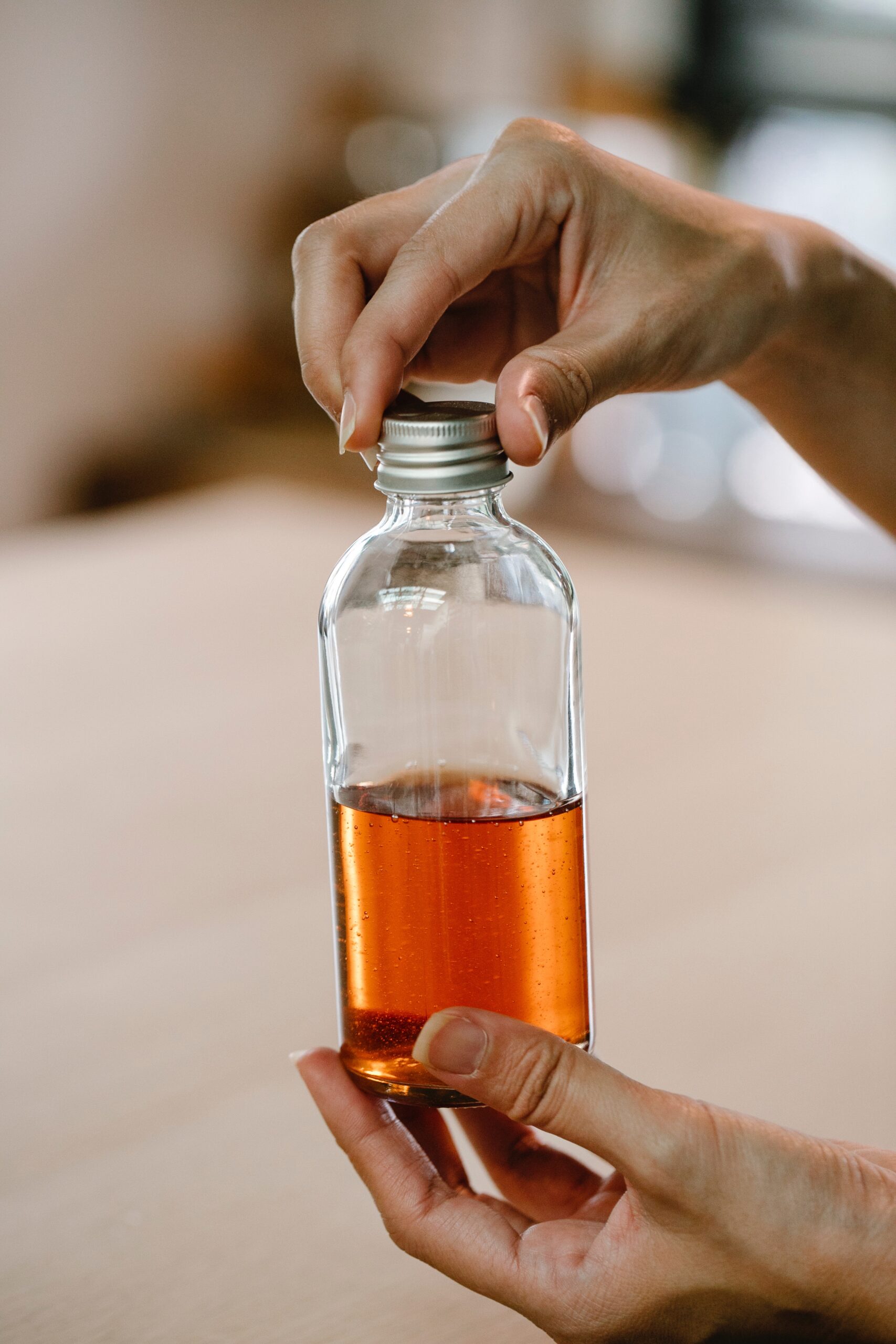 Crop person showing bottle with vanilla extract