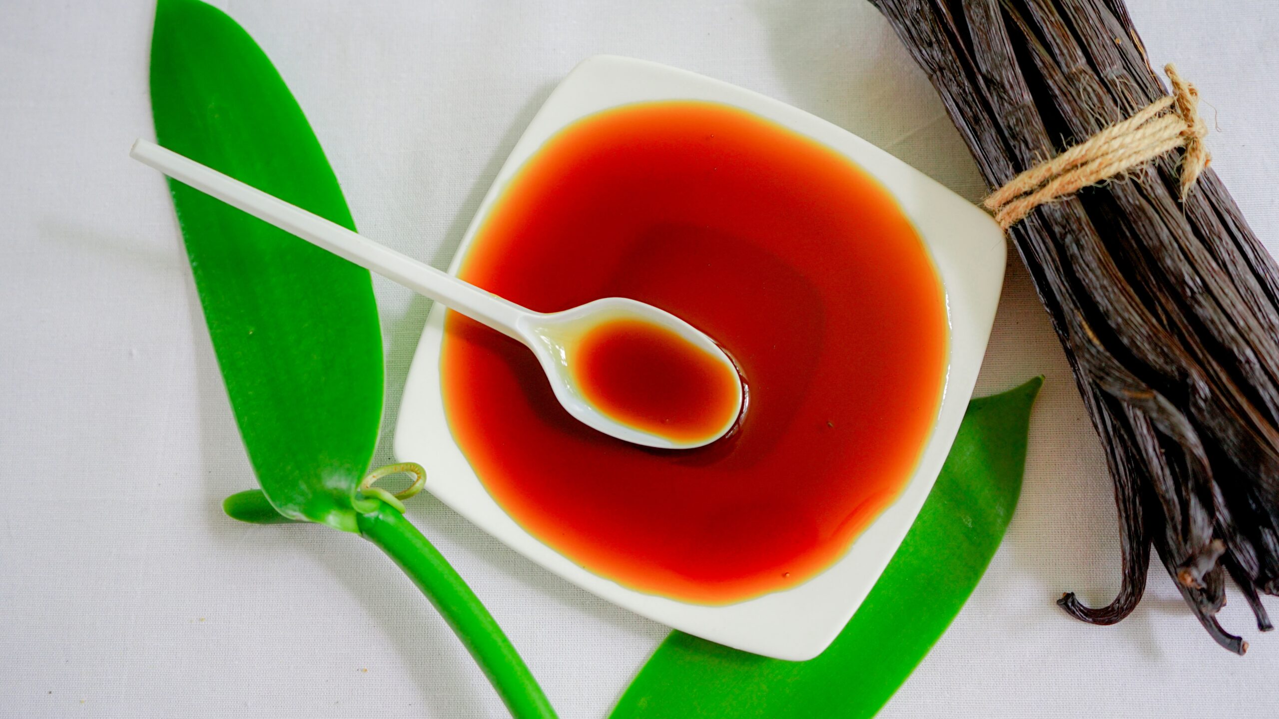 A spoon is in a bowl of vanilla essence