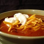 Bowl of chilli with sour cream and cheese