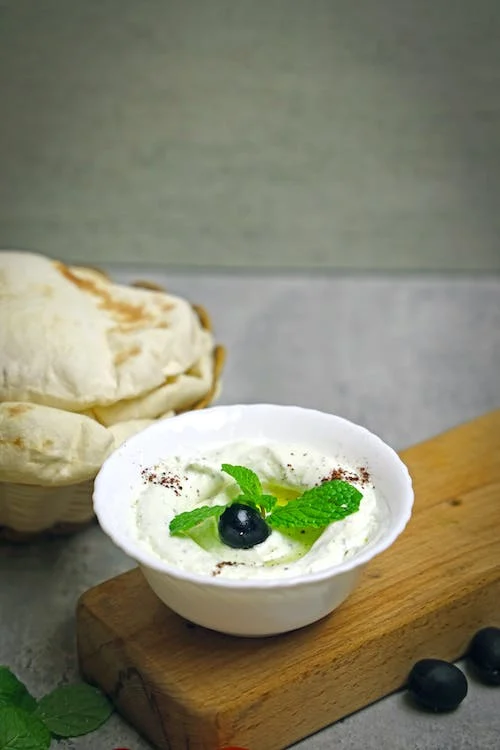 Sour Cream in White Bowl with Berry and Mint Leaves